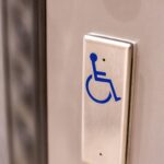 A,Metal,Button,With,A,Blue,Wheelchair,Symbol,On,It,