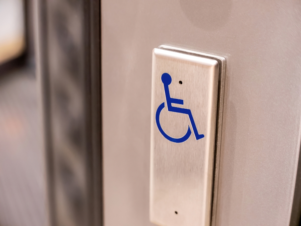 A,Metal,Button,With,A,Blue,Wheelchair,Symbol,On,It,